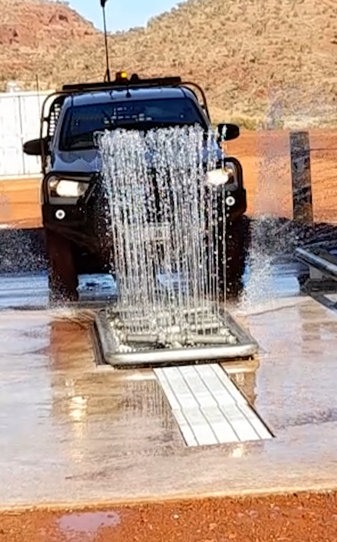 Drive-Through Wheel Wash System Removing Dirt and Debris